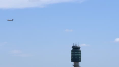 Airport-Scene-with-Aircraft-Flying-Behing-Air-Traffic-Control-Tower-4K