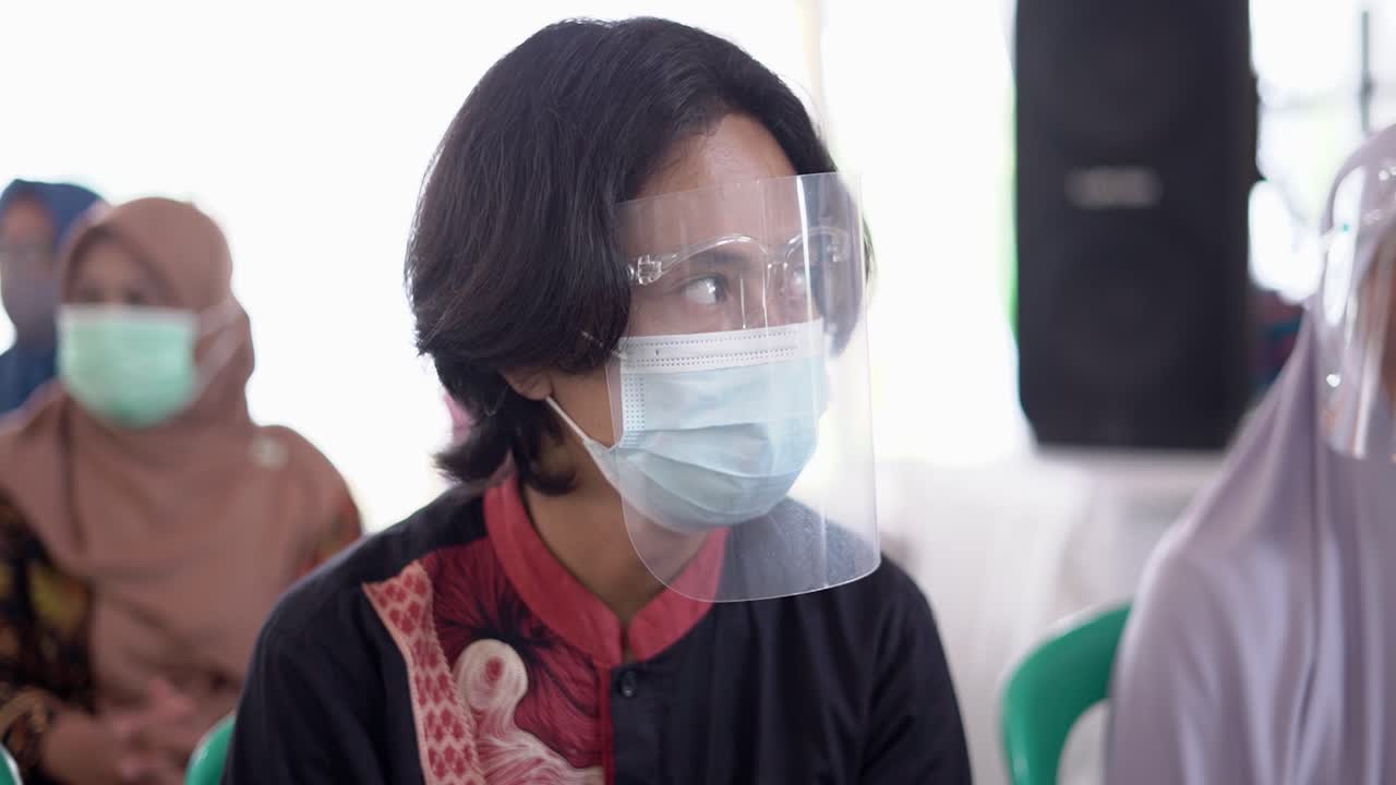 Young asian man wear face shield and mask during a pandemic in West Java, Indonesia