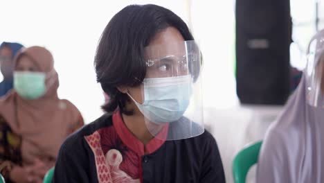 young asian man wear face shield and mask during a pandemic in west java, indonesia