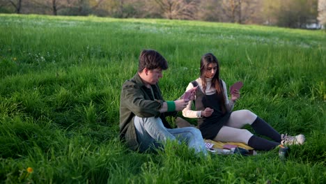 couple playing cards in a park