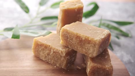 pile of jaggery cubes on wooden board