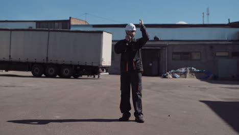 industrial worker communicating with a radio at a truck yard