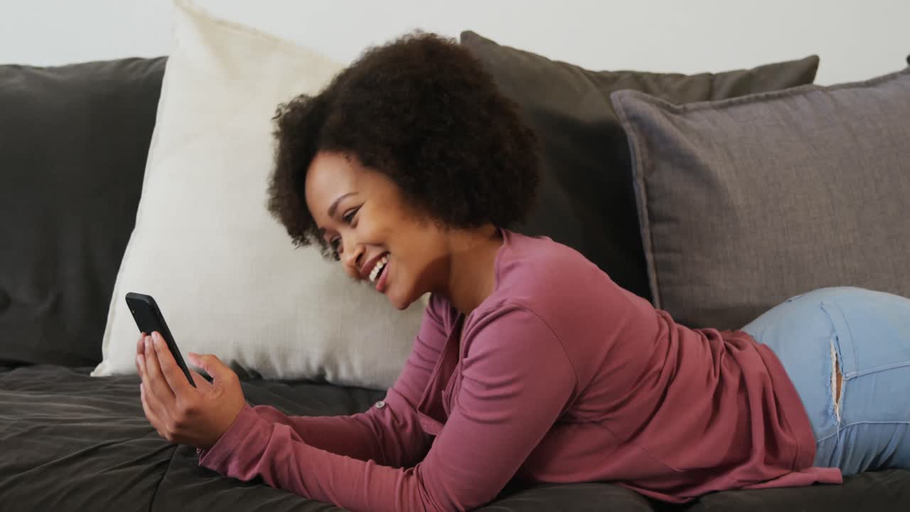 Woman using smartphone in living room