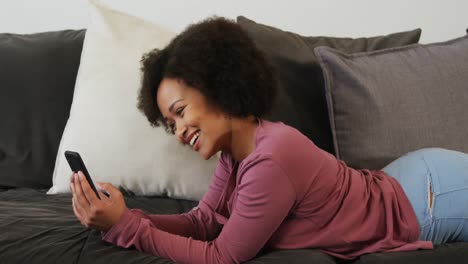 woman using smartphone in living room