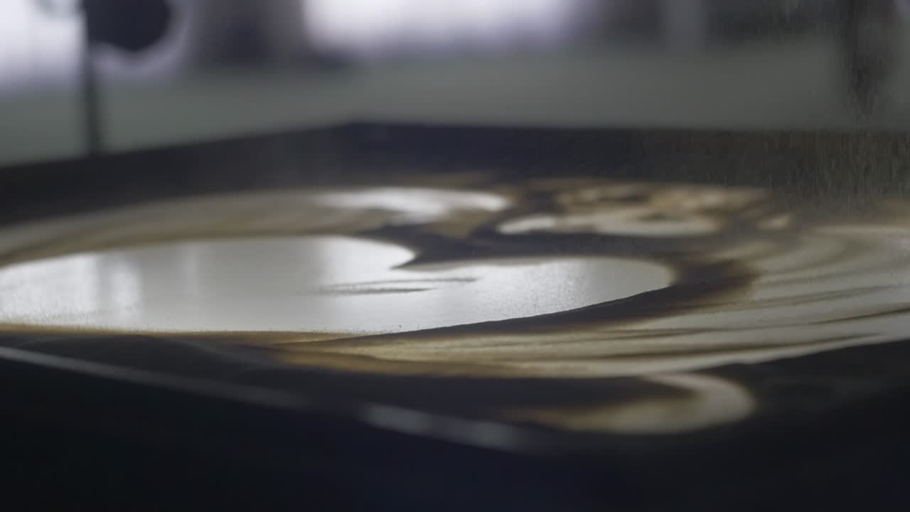 Female hands are painting on the sand