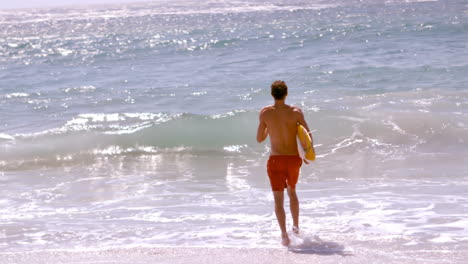 A-man-is-running-with-his-surfboard-