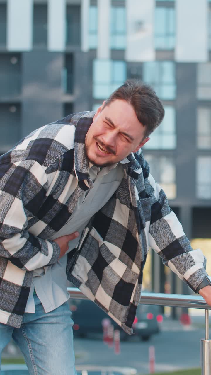 Caucasian mature man traveler feeling sudden strong abdominal stomach pain problem on city street