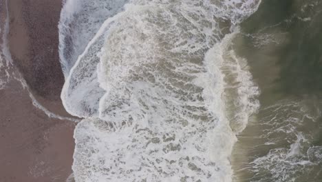 aerial footage shot topdown of the ocean in denmark at the western coast