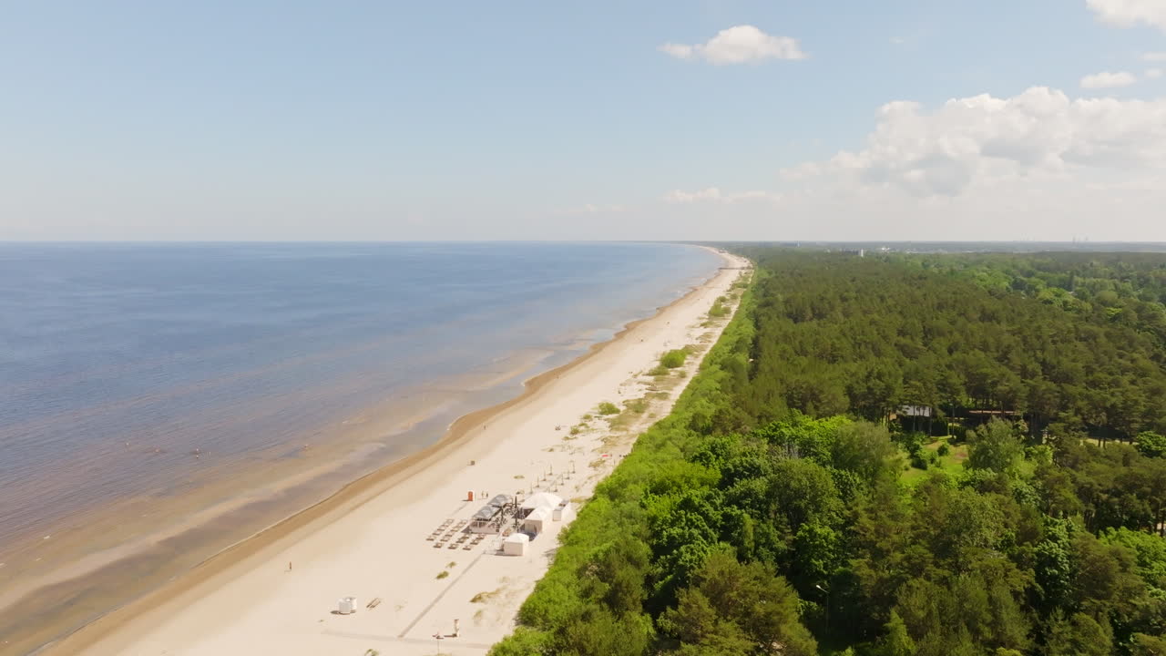 Aerial view rotating along the Jurmala beach, sunny, summer day in Riga, Latvia