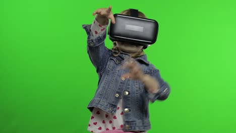 child girl using vr headset helmet to play game. watching virtual reality 3d 360 video. chroma key