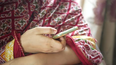 woman using a mobile phone in traditional attire