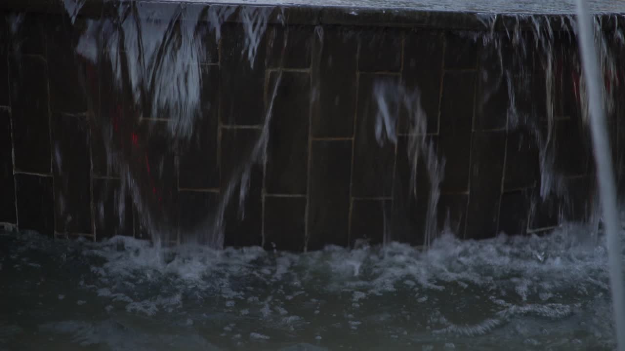A waterfall of strong water flowing in a public park at noon in an open place with beautiful view in Egypt, a video for calm and relaxation with the sound of water