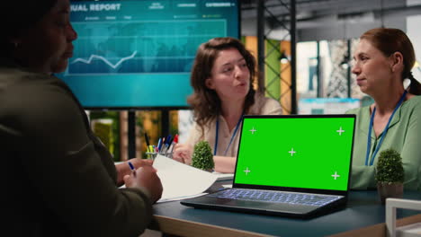 diverse women using chroma key mockup for business performance indicators