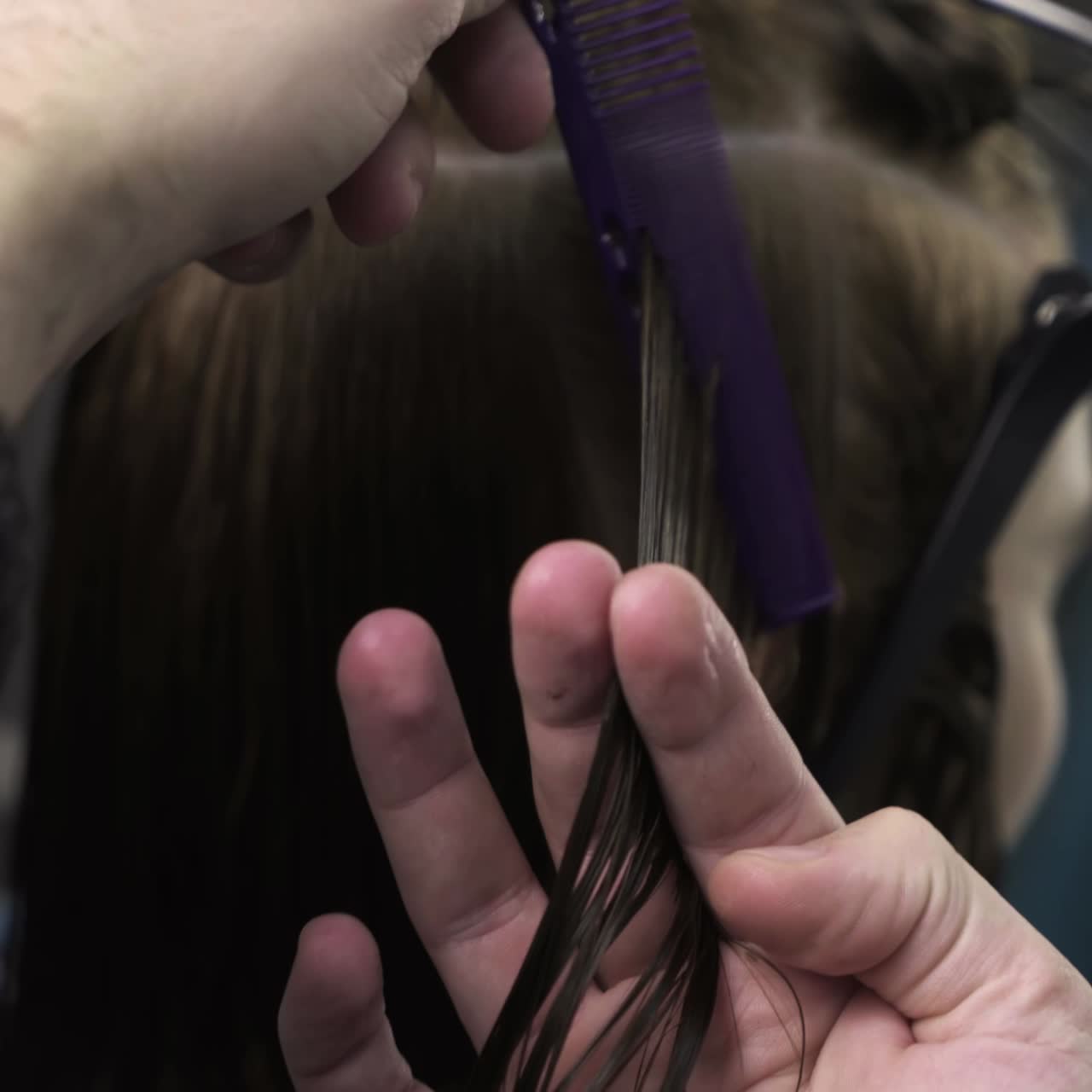 Hairdresser cutting hair of her customer