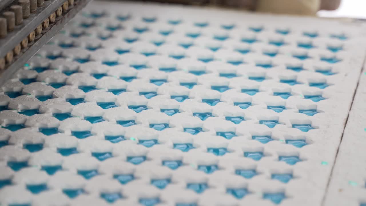 Close up of tray of blue stars, jelly beans, sugar, gums, industrial