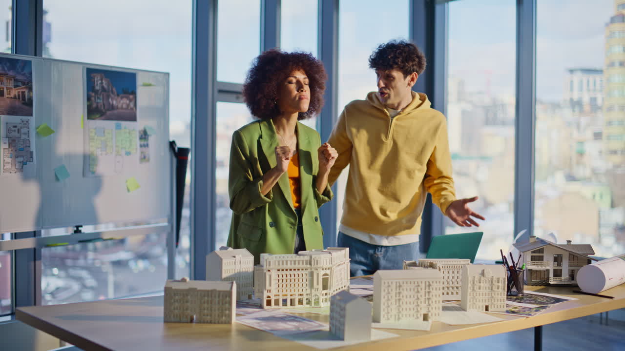 Angry executive talking smartphone working with man at architectural company