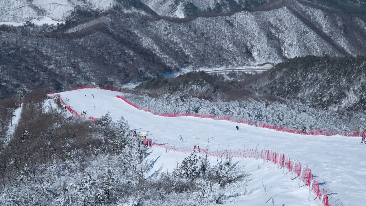 People Skiing Downhill of Balwangsan Mountain Slopes in Yong Pyong Ski Resort Pyeongchang-gun - Slow Motion Aerial view