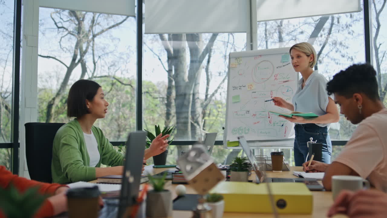 Experienced business coach speaking conference room. Team listening presentation