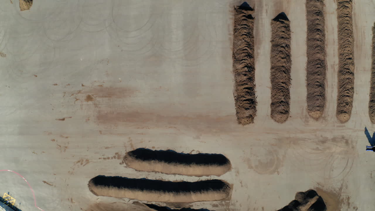 Aerial View of Large Dirt Piles at an Industrial Site