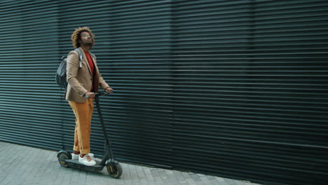 Young-Black-Man-Riding-E-Scooter-in-City