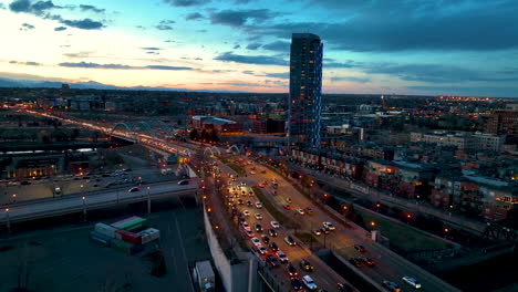 heavy traffic flowing along speer boulevard in downtown denver, twilight aerial
