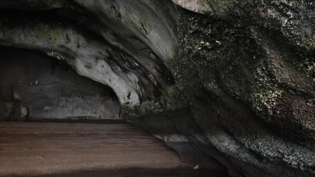 Wooden board slides to uncover a cave opening