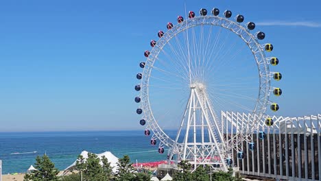 sokcho eye ferris wheel in sokcho, south korea, slowly turning on summer day