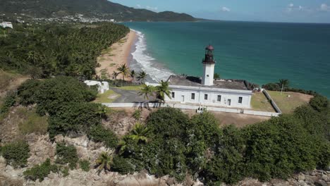 lighthouse on coastline cliff drone aerial dramatic beautiful destination tourism