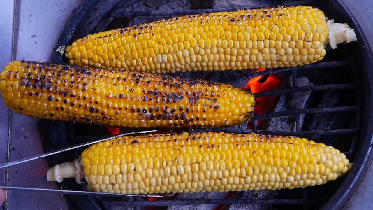 Turning Corn on the Cob on a Hot Barbecue Grill