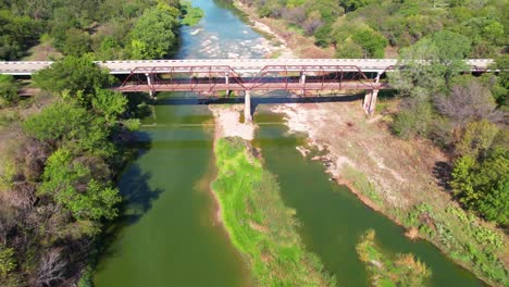 aerial flight over the brazos river and flying over the old brazos point bridge in texas