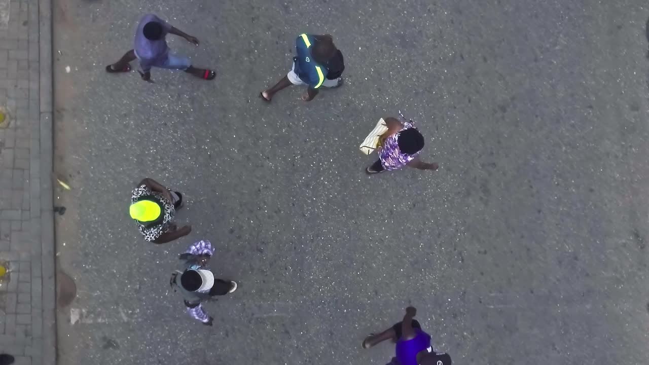 People waiting on the street as a taxi passes in Accra, Ghana