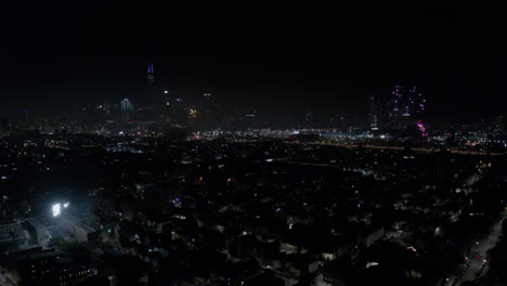 Large-purple-fireworks-explode-followed-by-white-fireworks-over-the-city-of-Chicago-with-the-Willis-Tower-in-the-skyline-during-the-New-Years-Eve