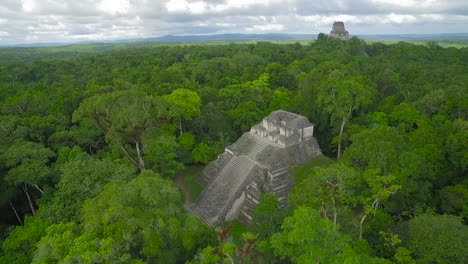 spectacular aerial shot over the tikal pyramids in guatemala 3