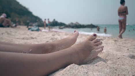 woman in blue bikini comes into transparent warm ocean