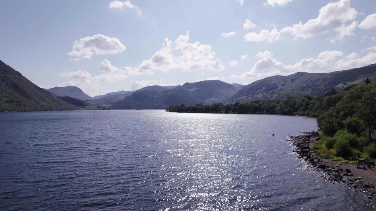 화창한 날, 호수 지구, 컴브리아, 영국에 얼스워터 위로 앞으로 날아가는 낮은 드론 샷