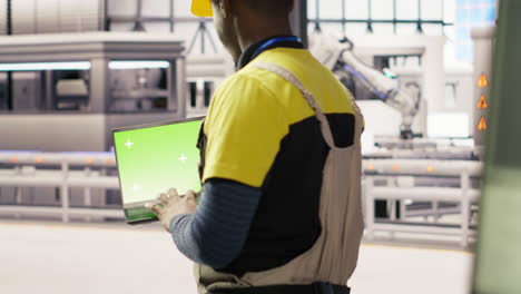 smart factory mechanic testing automated systems using isolated screen laptop