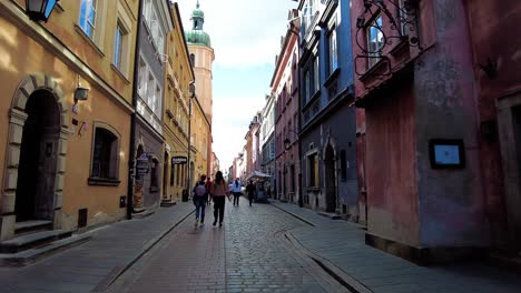 walking down the cobblestone street in old town of warsaw in poland