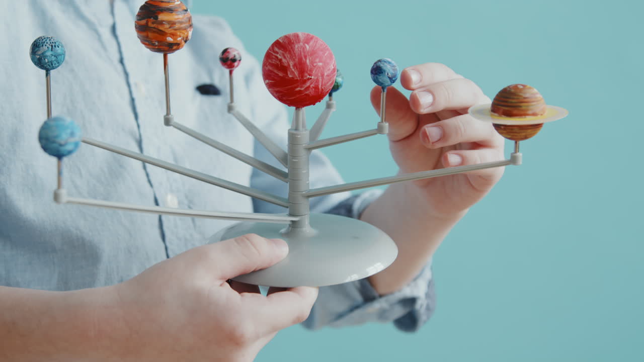 Cute Boy Playing with Solar System Model Toy