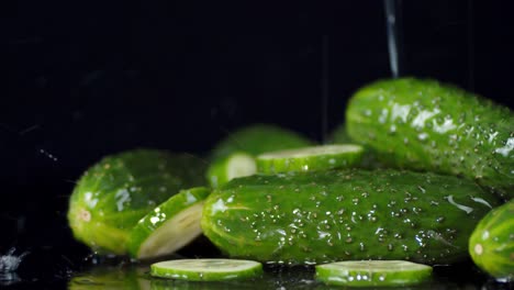 fresh cucumbers falling water drops.