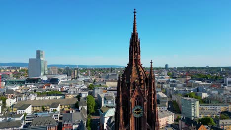 4k aerial drone video of the clock tower of the historic kaiserdom st. bartholomäus church in downtown frankfurt, germany