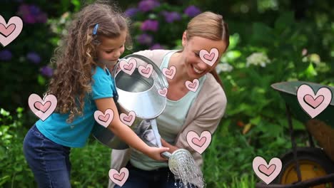 animación de corazones rosados sobre una madre caucásica feliz con su hija sosteniendo una lata de riego