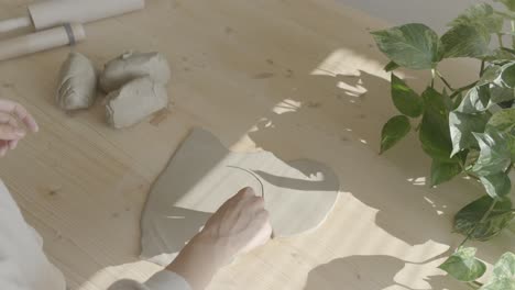 a female ceramicist working with clay