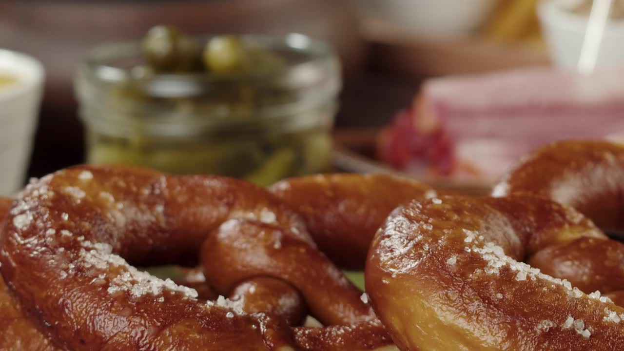 Hand Placing Freshly Baked Pretzel on Wooden Board