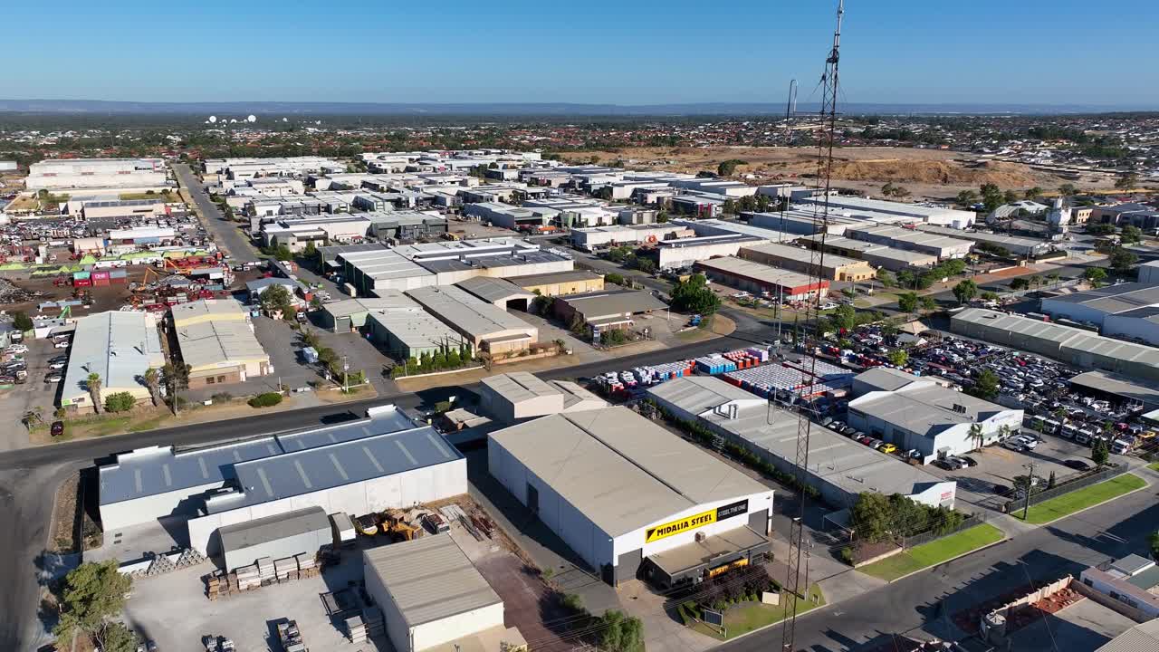 Aerial shot of a wide spread industrial area at countryside during daytime.
