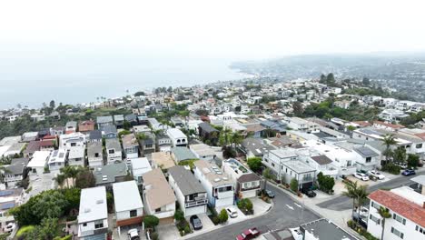 packed neighborhood and a view of the ocean aerial dolly 60fps
