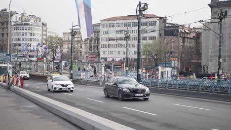 a busy street scene in istanbul, turkey with cars, buses, people, and a hop on hop off tour bus