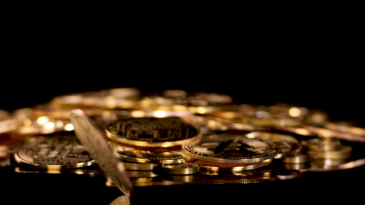 Gold coin spins atop stacked coins, dramatic lighting, black background, slow camera tracking