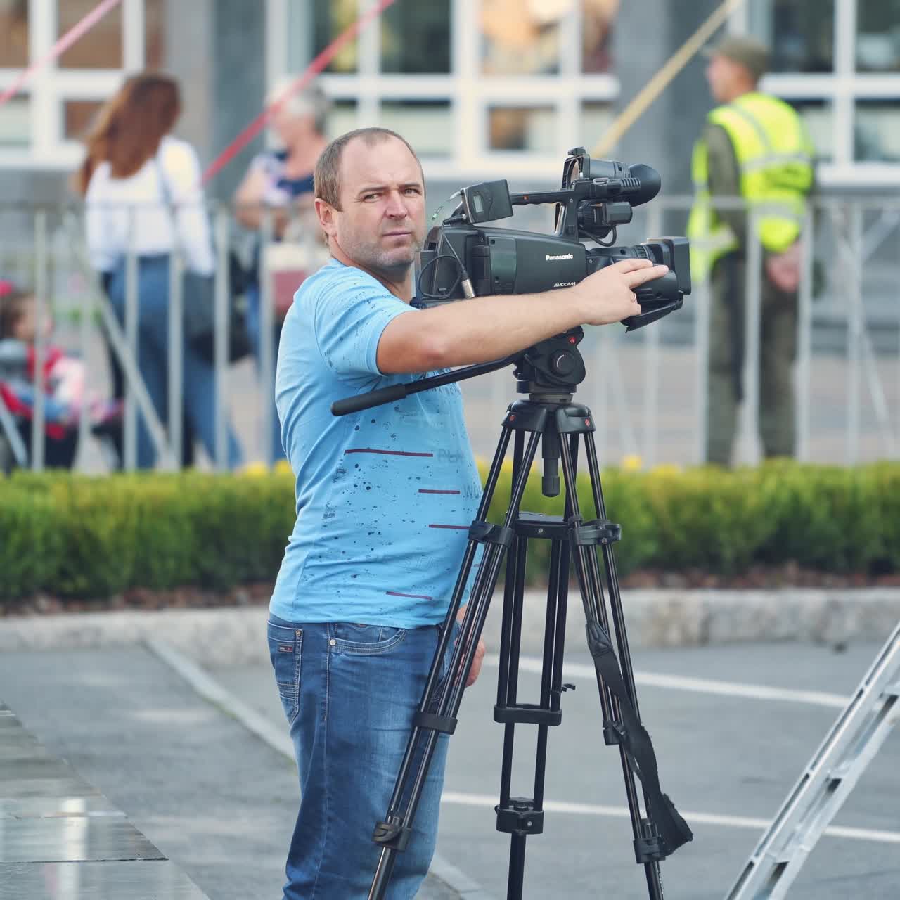 Man with video camera in city