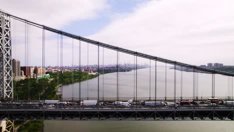 long aerial side view of suspension bridge with traffic