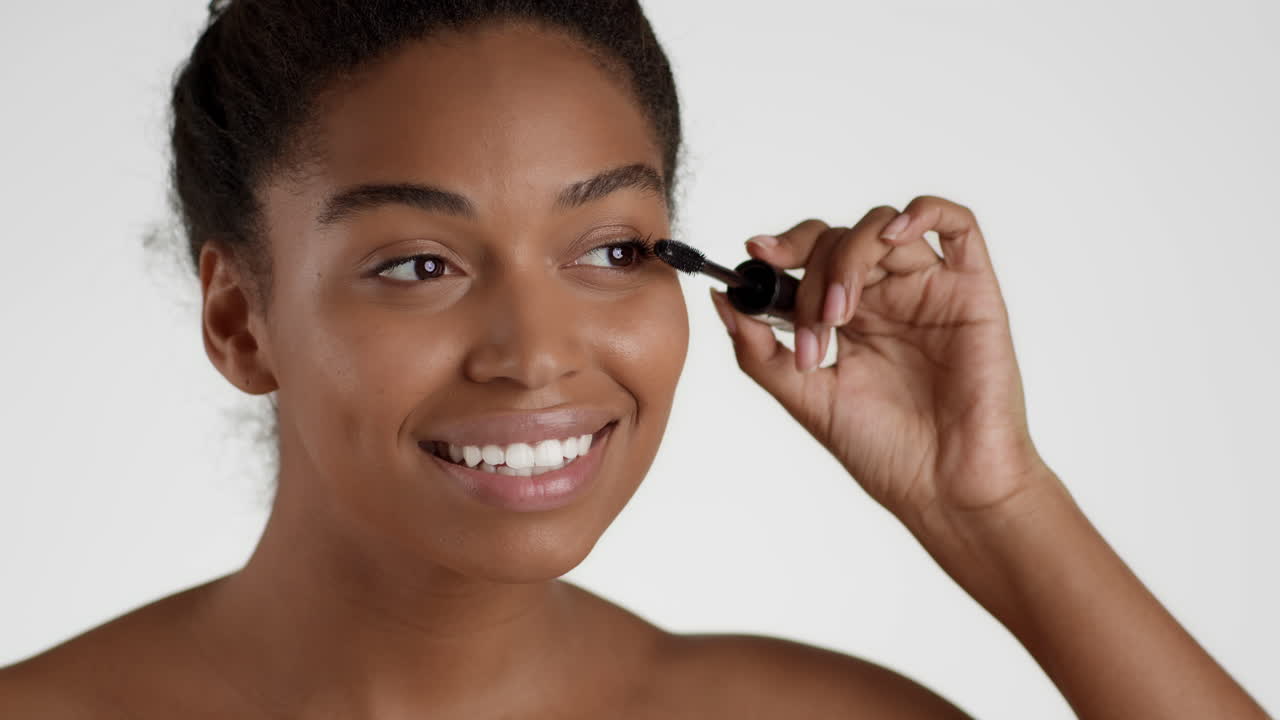 Woman applying mascara